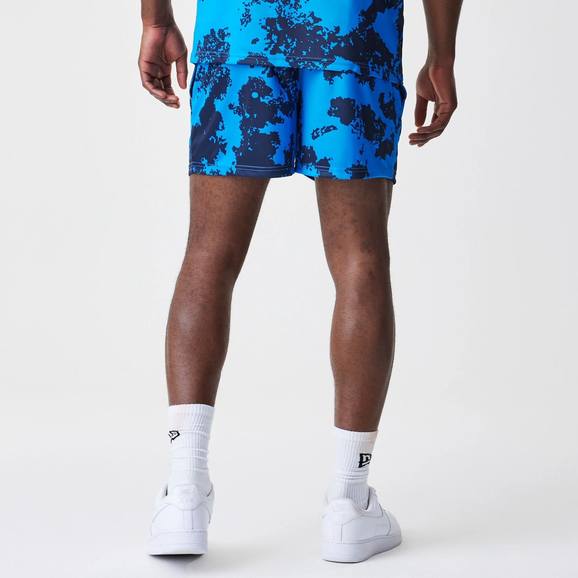 The Male model is wearing Red Bull Racing Graphic Blue Football Shorts 2