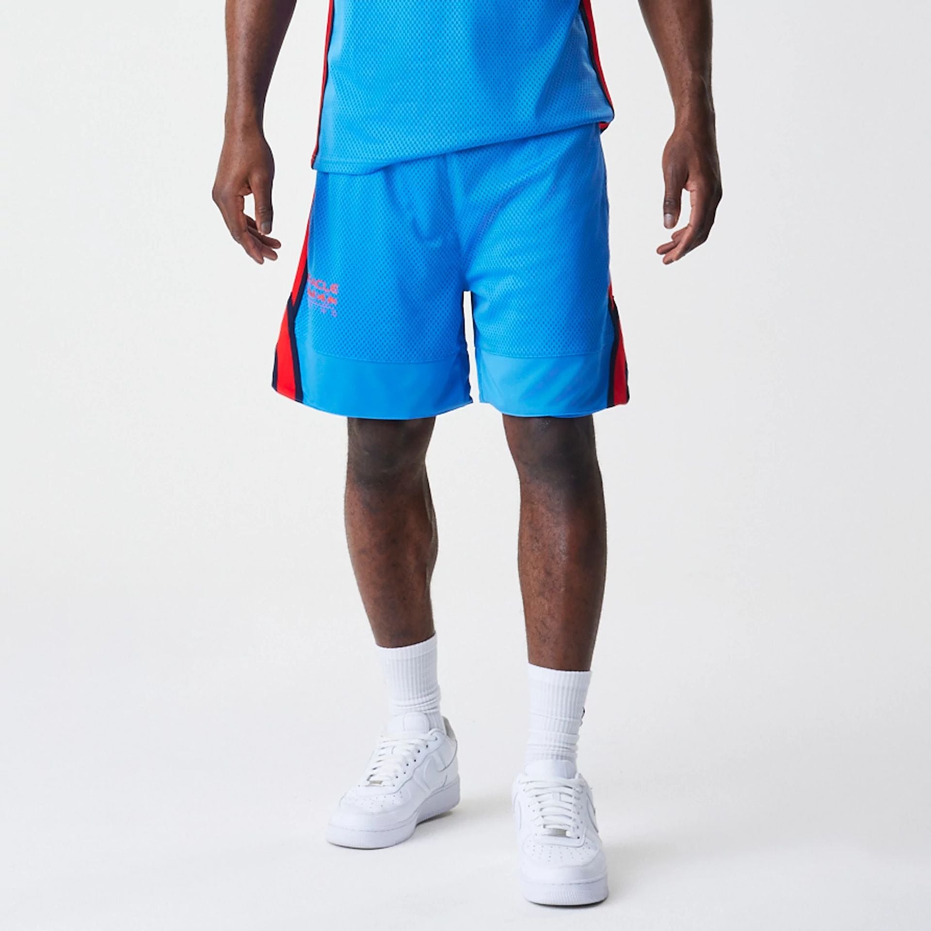 The Male model is wearing Red Bull Racing Basketball Mesh Blue Shorts 1