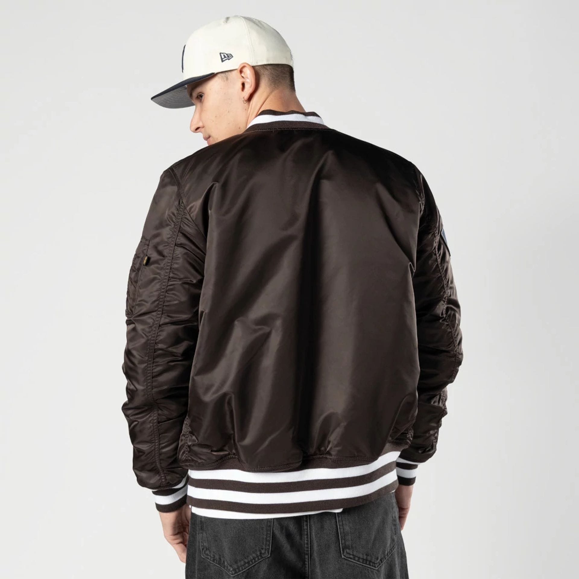 The Male model is wearing New York Yankees MLB X Alpha Dark Brown Bomber Jacket 2