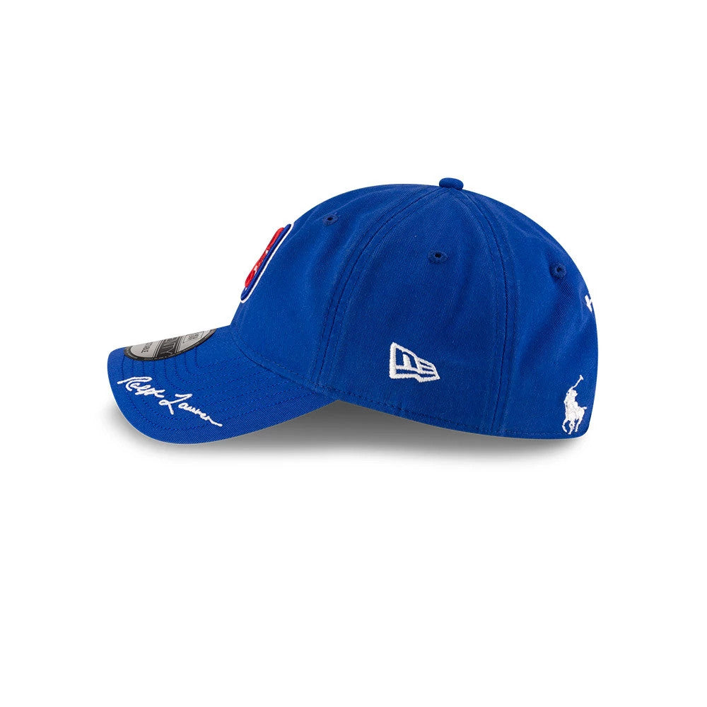 Chicago Cubs Ralph Lauren X MLB Open Blue New Era 9TWENTY Adjustable Cap, side view showing the white New Era flag logo and the Ralph Lauren Polo Pony logo embroidered on the blue fabric with Ralph Lauren's signature on the blue visor.