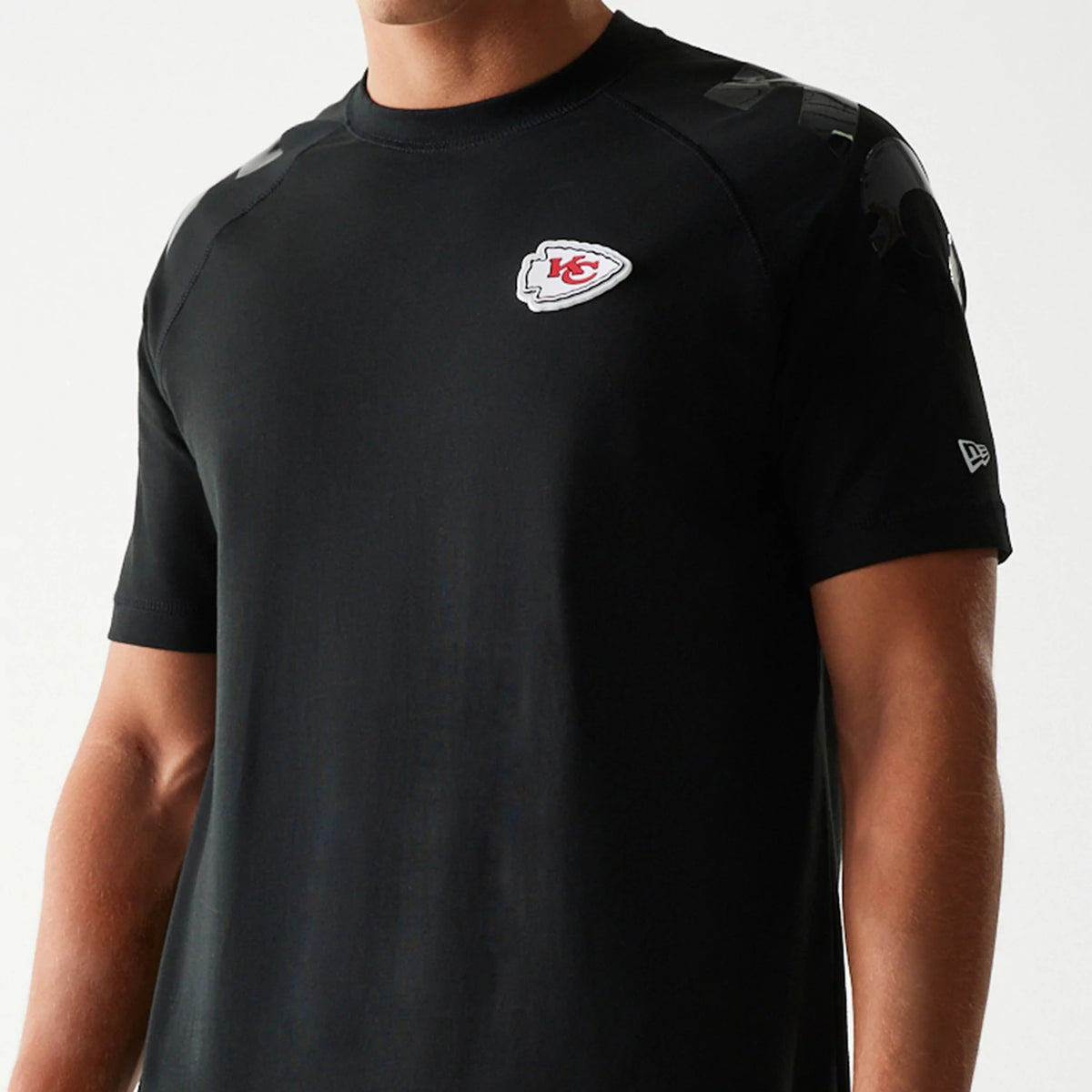 New Era Kansas City Chiefs NFL 3RD Down Black T-Shirt, front view showing the round neckline and a printed team logo on the left chest, with design details on the shoulders and a small embroidered New Era logo on the left sleeve.