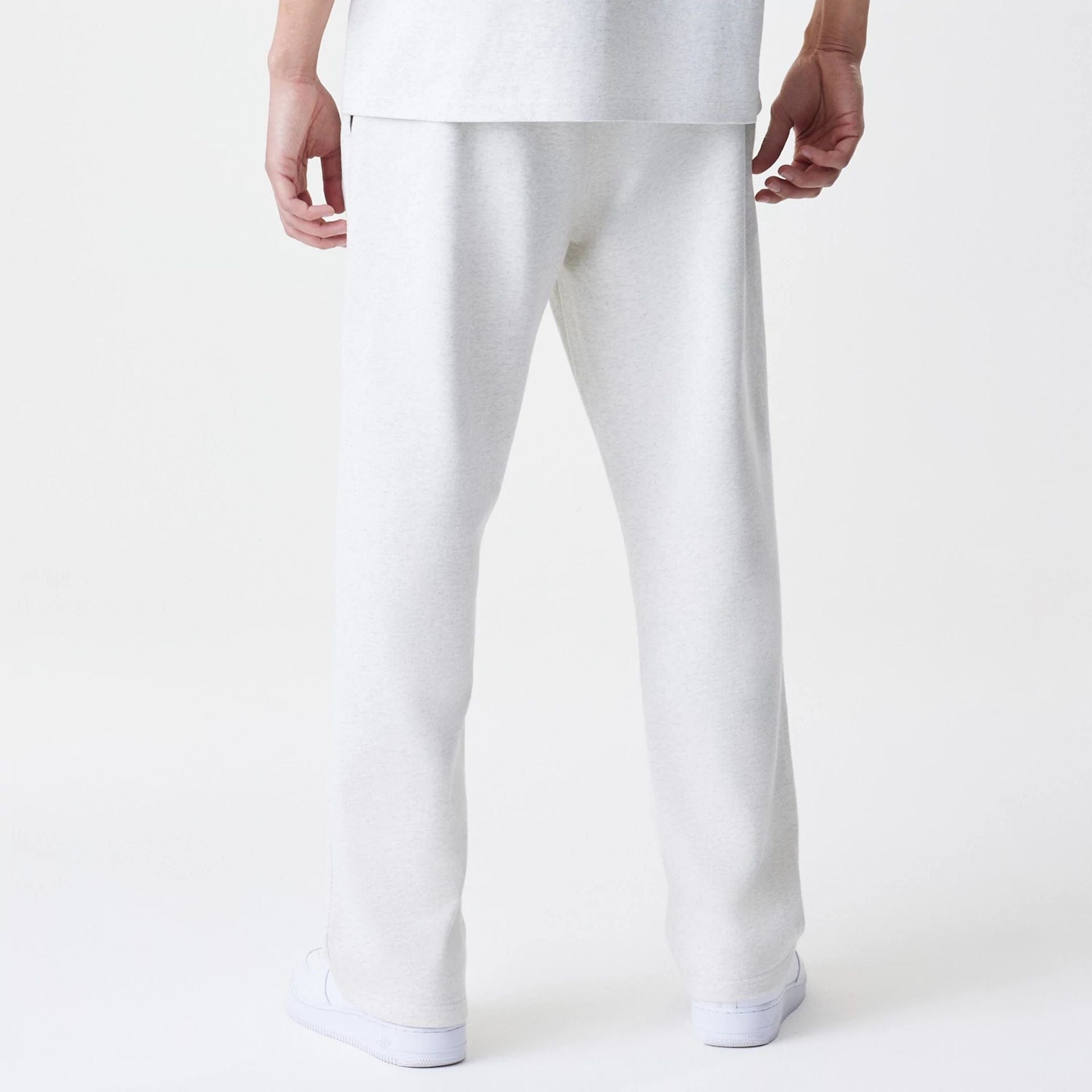 The Male model is wearing New Era Premium Essential Pastel Grey Joggers 2