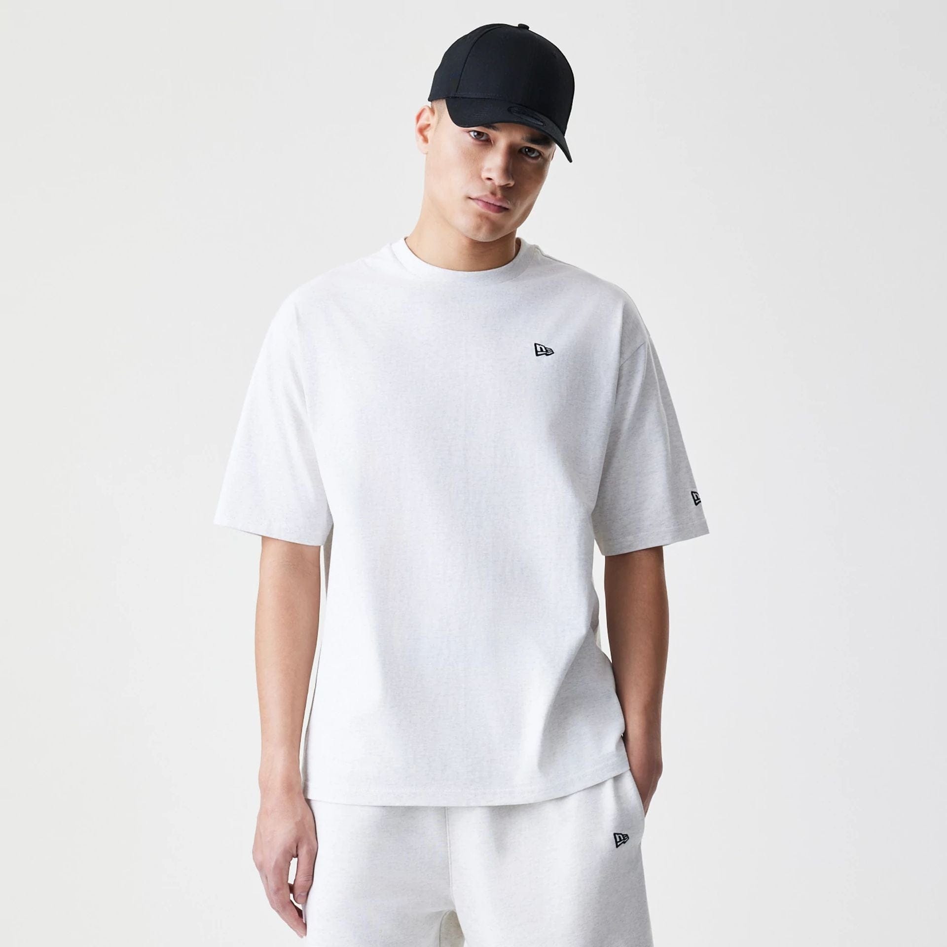 The Male model is wearing New Era Premium Essential Pastel Grey Oversized T-Shirt 1