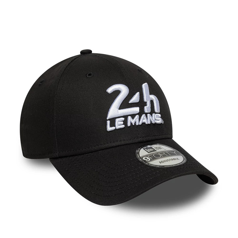 24HR Le Mans Core Black New Era 9FORTY Adjustable Cap, three-quarter view showing the white embroidered 24H Le Mans logo on the front panel, pre-curved black visor, and 9FORTY size sticker on the visor.