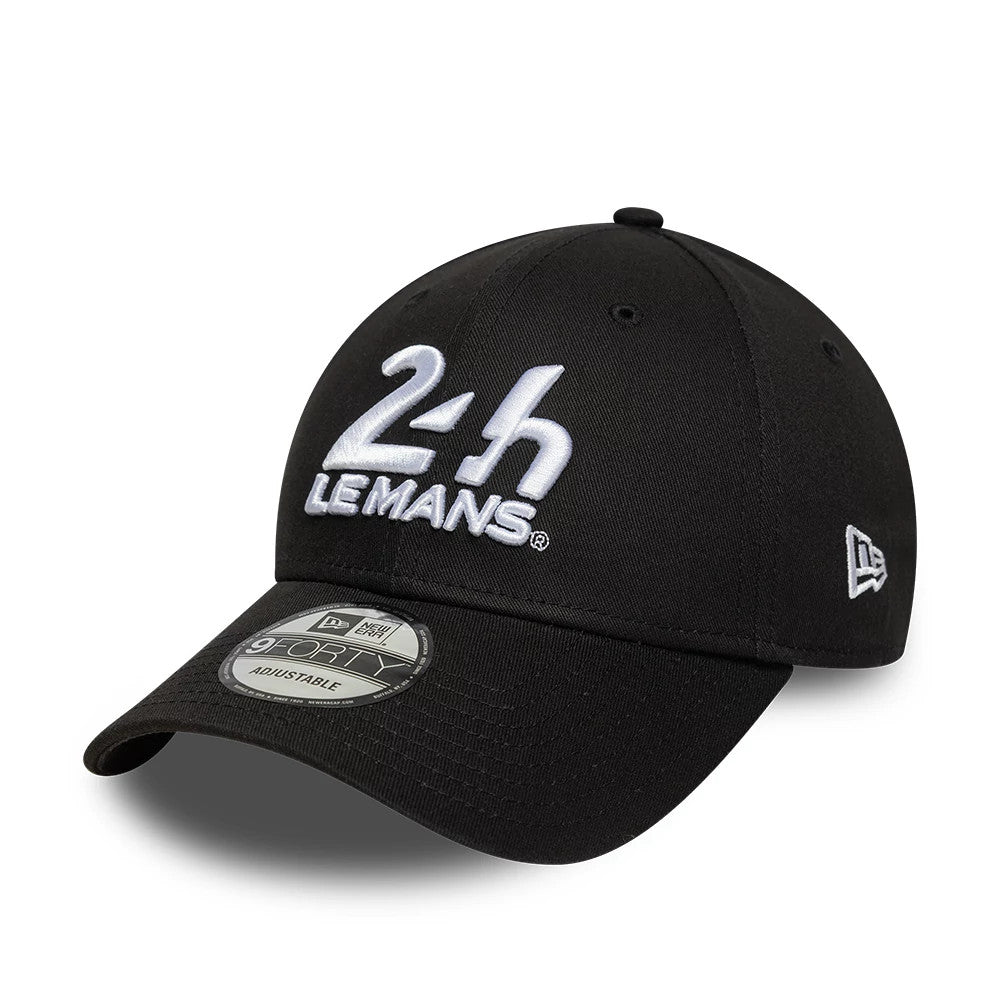 24HR Le Mans Core Black New Era 9FORTY Adjustable Cap, three-quarter view showing raised white embroidered 24H Le Mans logo on the front panel, curved black visor with 9FORTY size sticker, and New Era flag logo on the left side.