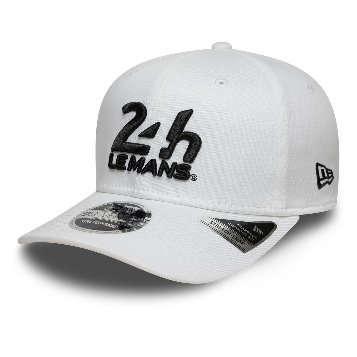 24HR Le Mans Core White New Era 9SEVENTY Stretch Snap Adjustable Cap, front view showing the black raised embroidery 24H LeMans logo on the white crown, curved white visor with a 9SEVENTY size sticker, and New Era flag logo on the left side.
