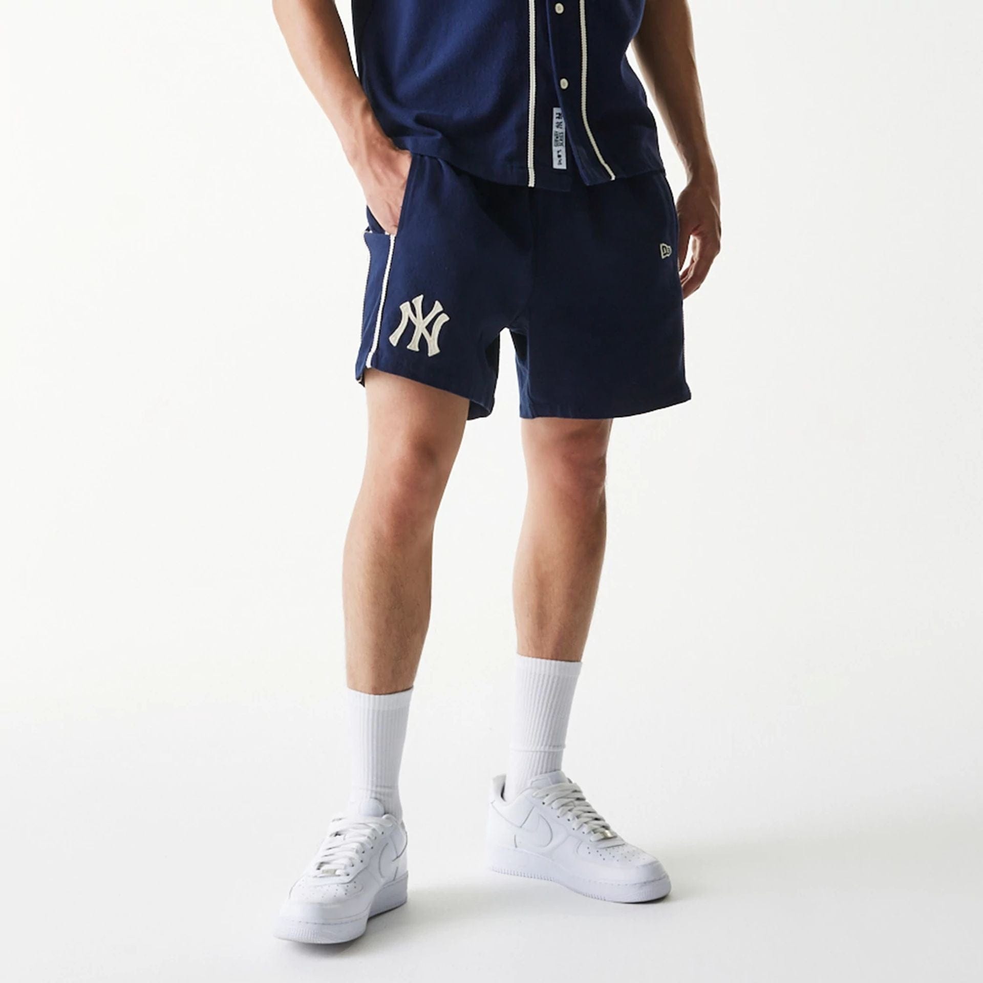 The Male model is wearing New York Yankees MLB Piping Navy Shorts 1