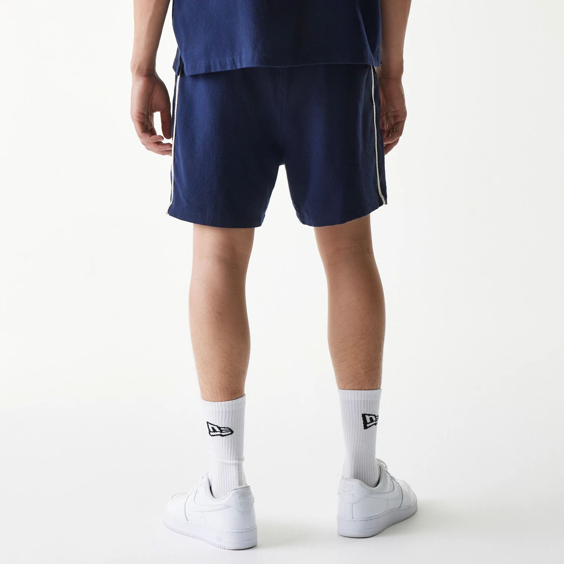 The Male model is wearing New York Yankees MLB Piping Navy Shorts 2
