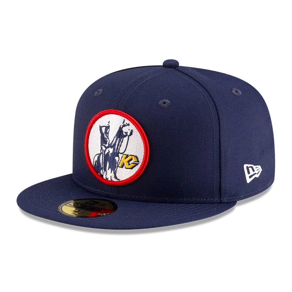 Kansas City Scouts NHL Basic Navy New Era 59FIFTY Fitted Cap, three-quarter view showing a red bordered embroidered front logo, the navy visor with a gold 59FIFTY size sticker and the New Era flag logo on the left side.