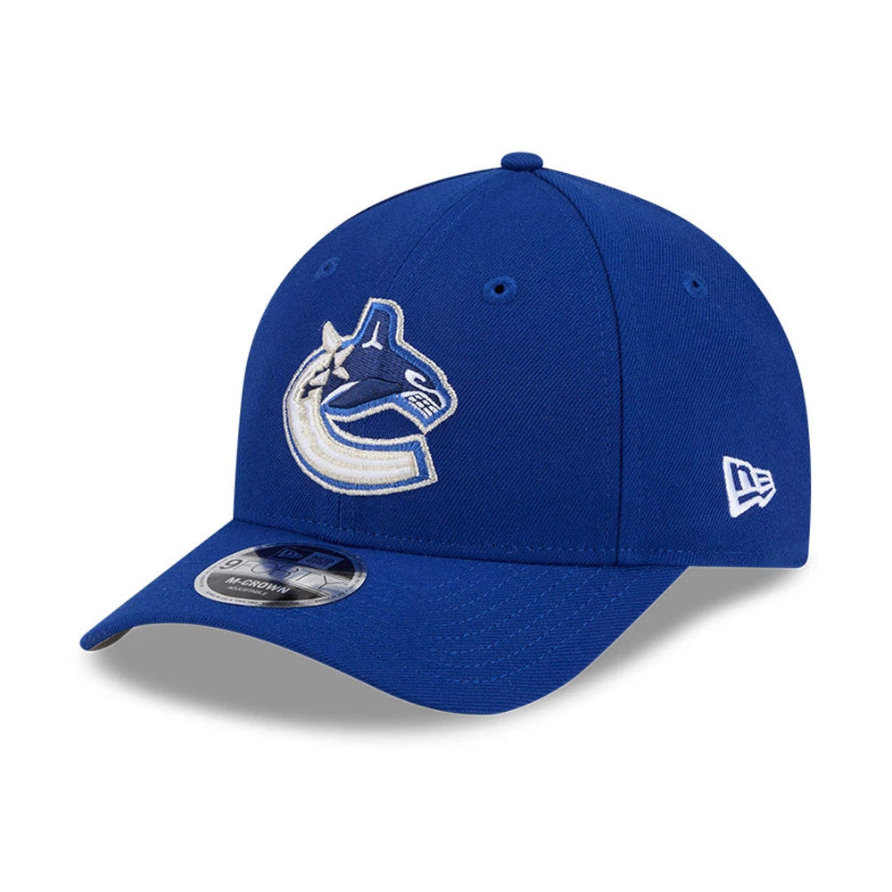 Vancouver Canucks NHL Team Blue New Era 9FORTY M-Crown Adjustable Cap, three-quarter view showing the raised embroidered Canucks logo on the front panel, curved blue visor, and white New Era flag logo on the left side.
