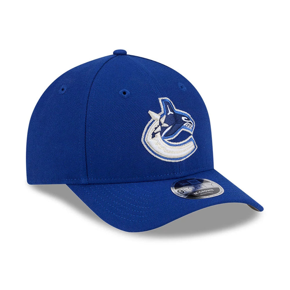 Vancouver Canucks NHL Team Blue New Era 9FORTY M-Crown Adjustable Cap, three-quarter view showing the raised white and blue Canucks logo embroidered on the front panels with a curved blue visor and 9FORTY size sticker displayed on the visor.