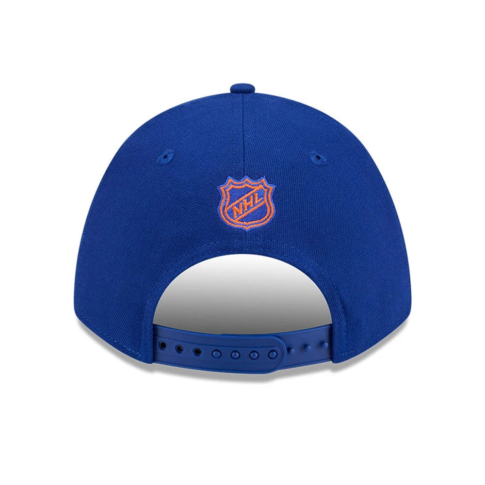 New York Islanders NHL Team Blue New Era 9FORTY M-Crown Adjustable Cap, rear view showing the orange embroidered NHL logo at the centre of the blue back panels, with an adjustable blue plastic strap and matching eyelets.