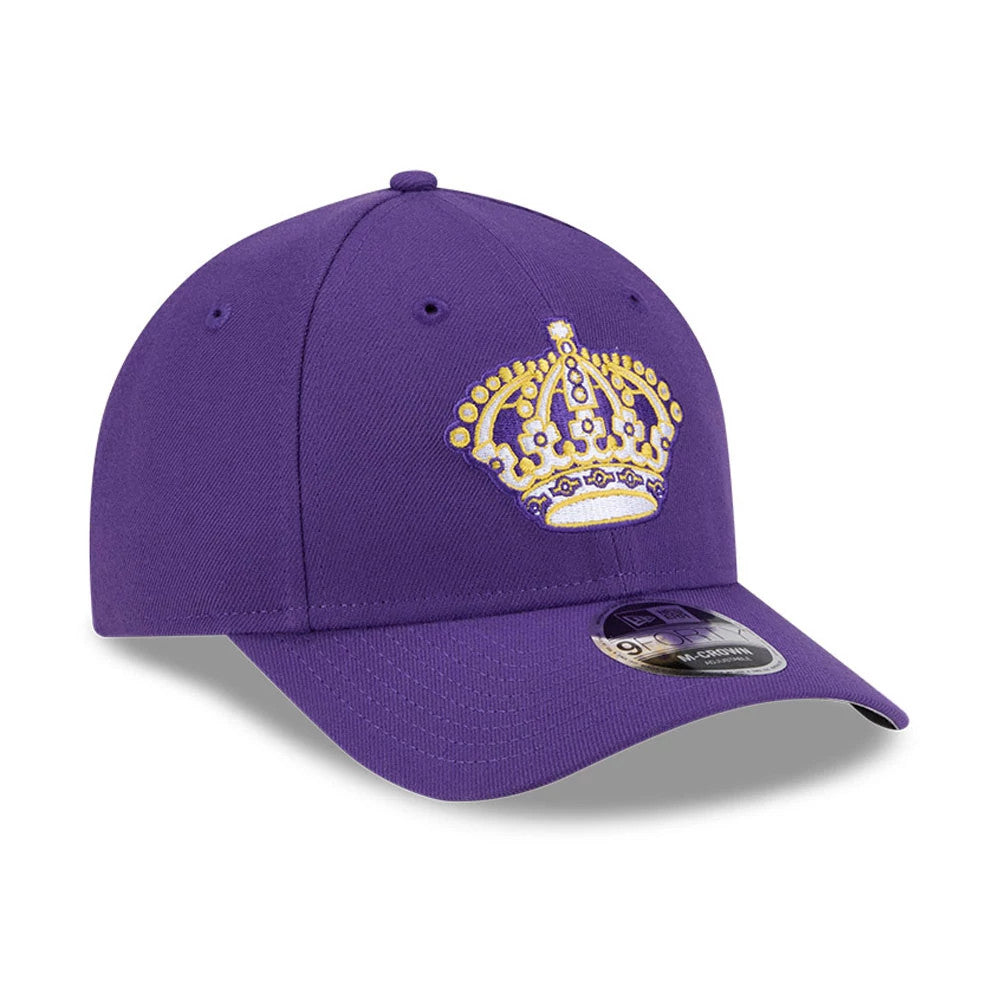 LA Kings NHL Team Purple New Era 9FORTY M-Crown Adjustable Cap, three-quarter view showing a gold and white embroidered crown logo on the front panel with a curved purple visor and 9FORTY size sticker on the left side.