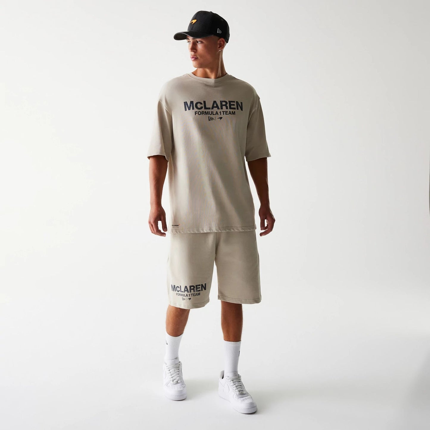 The Male model is wearing McLaren Racing Wordmark Light Beige Oversized Shorts 8