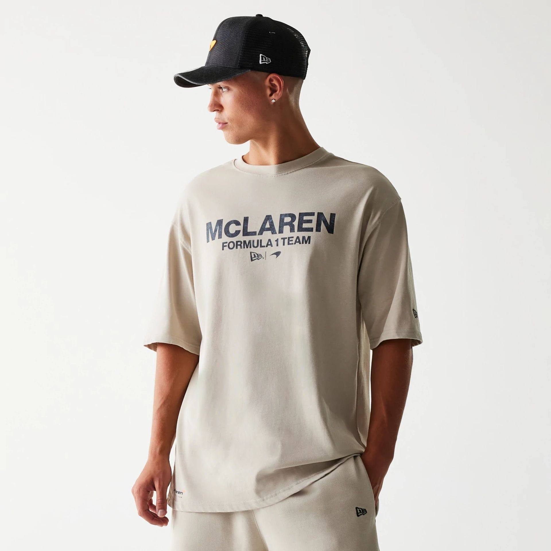 The Male model is wearing McLaren Racing Wordmark Light Beige Oversized T-Shirt 1