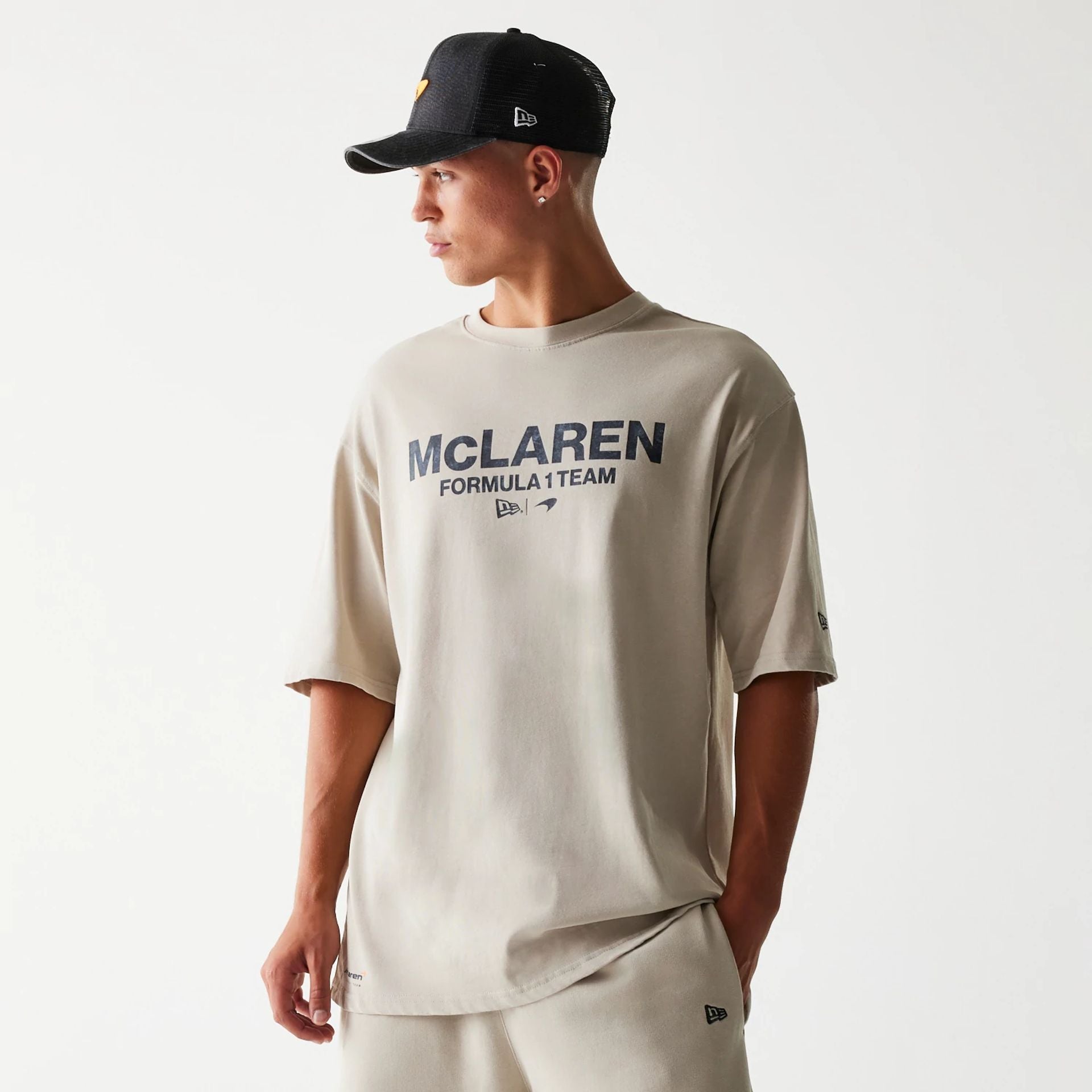 The Male model is wearing McLaren Racing Wordmark Light Beige Oversized T-Shirt 1