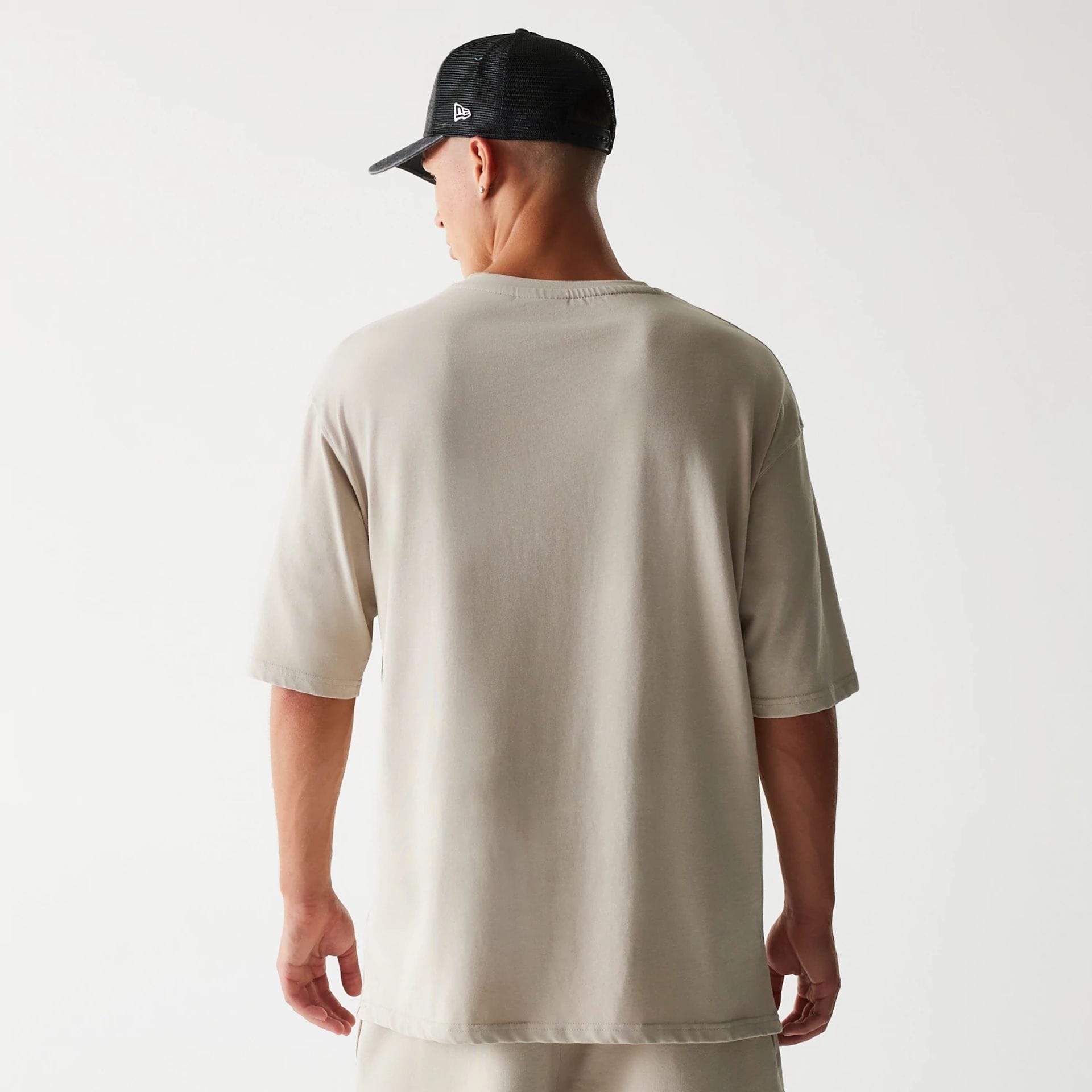 The Male model is wearing McLaren Racing Wordmark Light Beige Oversized T-Shirt 2