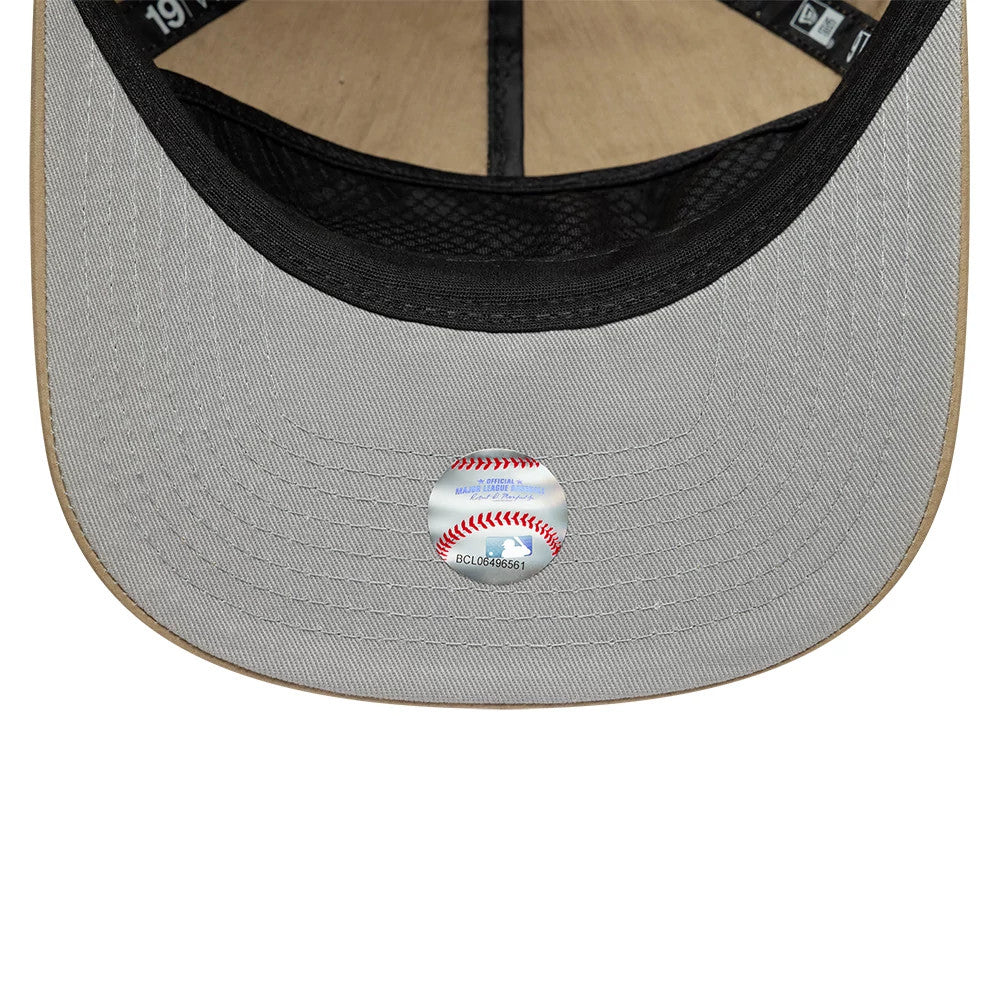 LA Dodgers MLB Nylon Open Beige New Era 19TWENTY Adjustable Cap, inside view showing the beige undervisor with a baseball-themed sticker, black internal taping, and a unstructured crown panel.