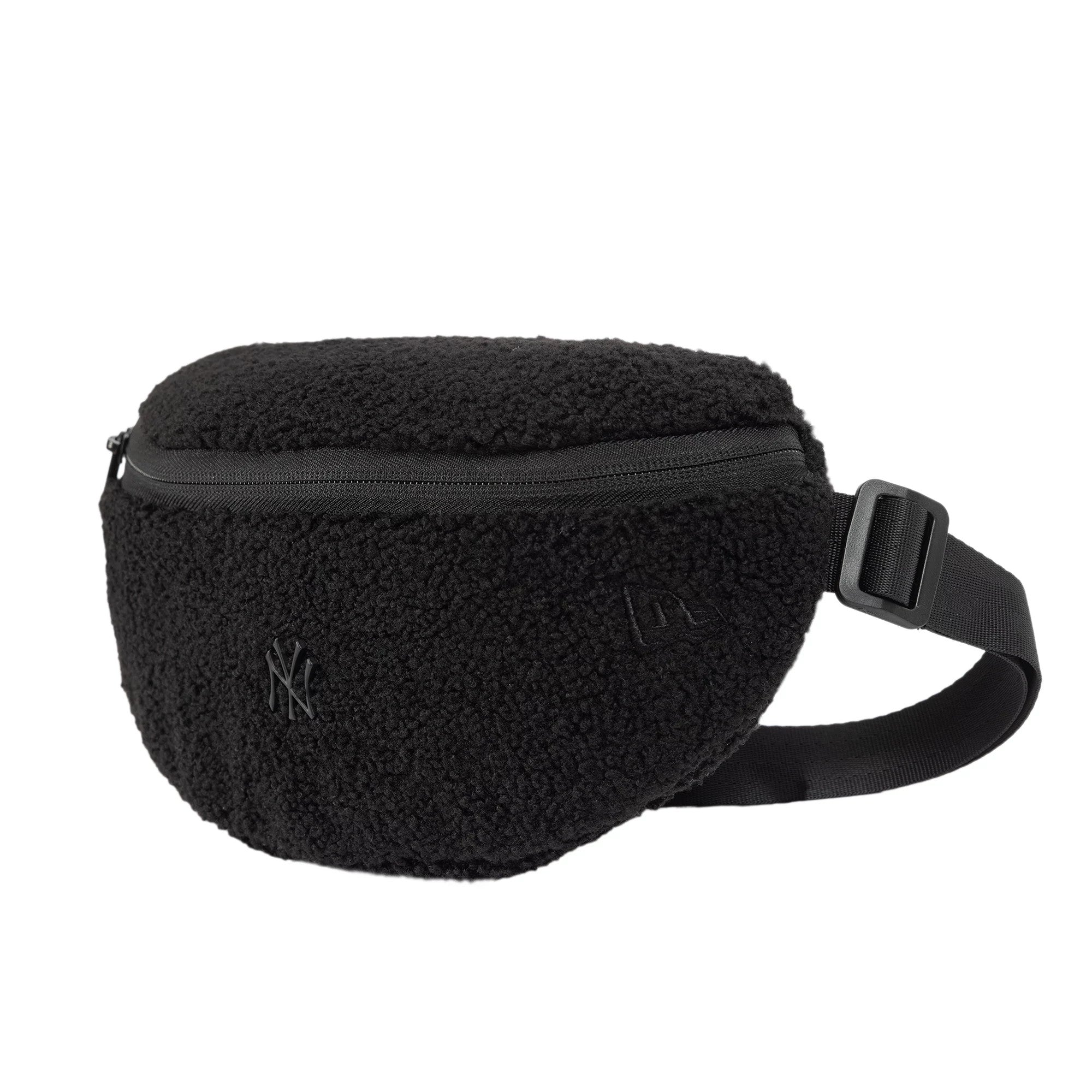 New Era New York Yankees MLB Borg Pin Black Waist Bag, three-quarter view highlighting the fluffy black texture, a raised New York Yankees logo on the front, a zip closure on top, and an adjustable black strap with a buckle on the side.
