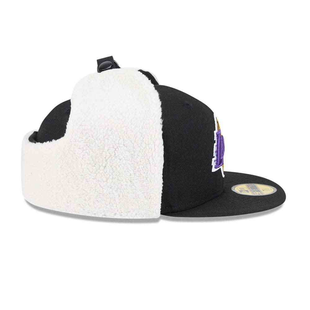 LA Lakers NBA Classic Black Dogear New Era 59FIFTY Fitted Cap, side view showing the purple and gold embroidered Lakers logo on the front panel, with white plush dogear flaps and a gold 59FIFTY size sticker on the visor.