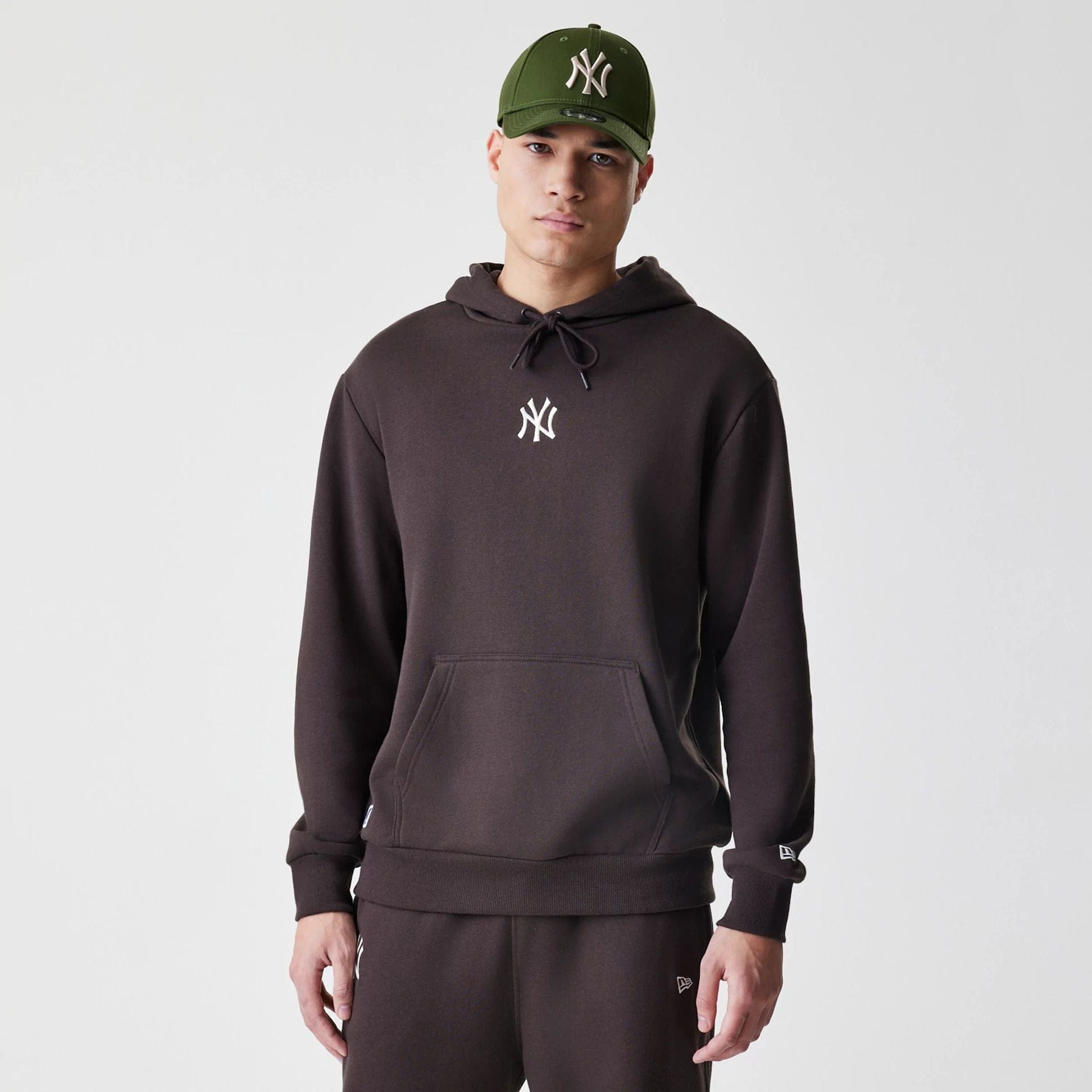 The Male model is wearing New York Yankees MLB Midi League Essential Dark Brown Oversized Pullover Hoodie 1