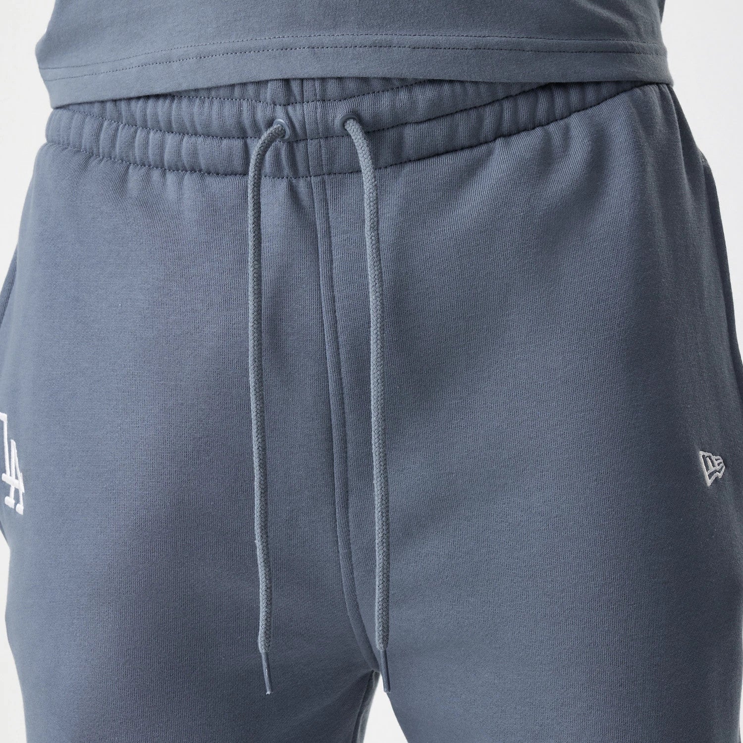 The Male model is wearing LA Dodgers MLB Midi League Essential Dark Grey Joggers 4