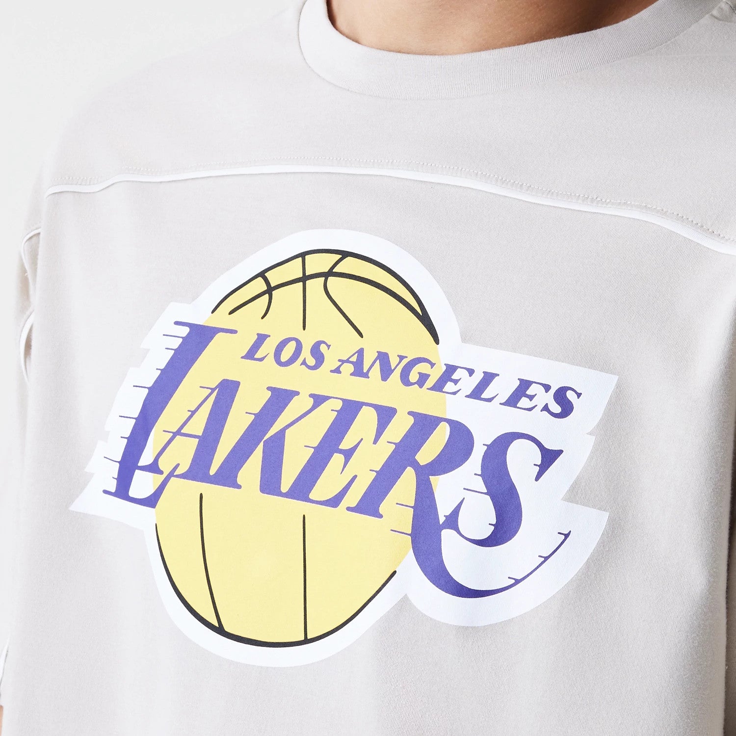 The Male model is wearing LA Lakers NBA Piping Light Beige Oversized T-Shirt 3
