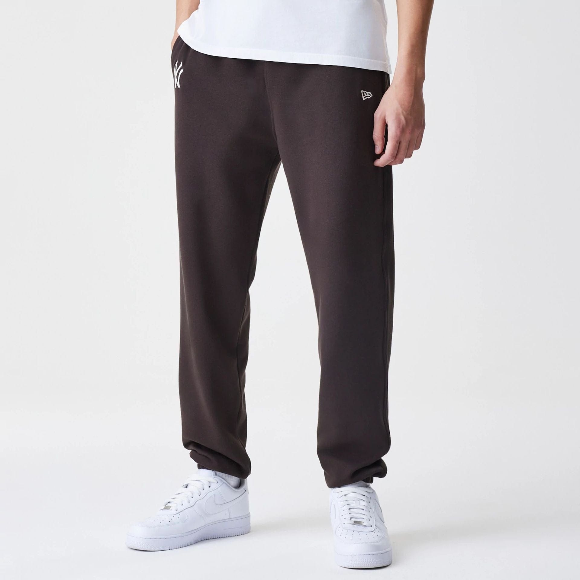 The Male model is wearing New York Yankees MLB Midi League Essential Dark Brown Joggers 1