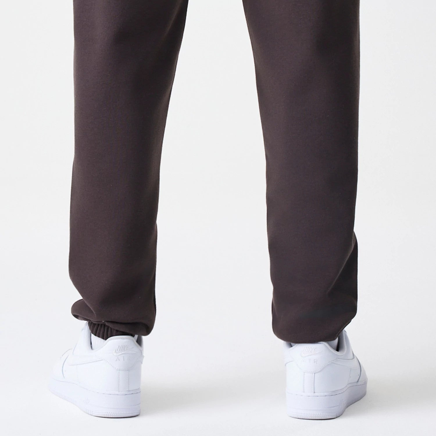 The Male model is wearing New York Yankees MLB Midi League Essential Dark Brown Joggers 4