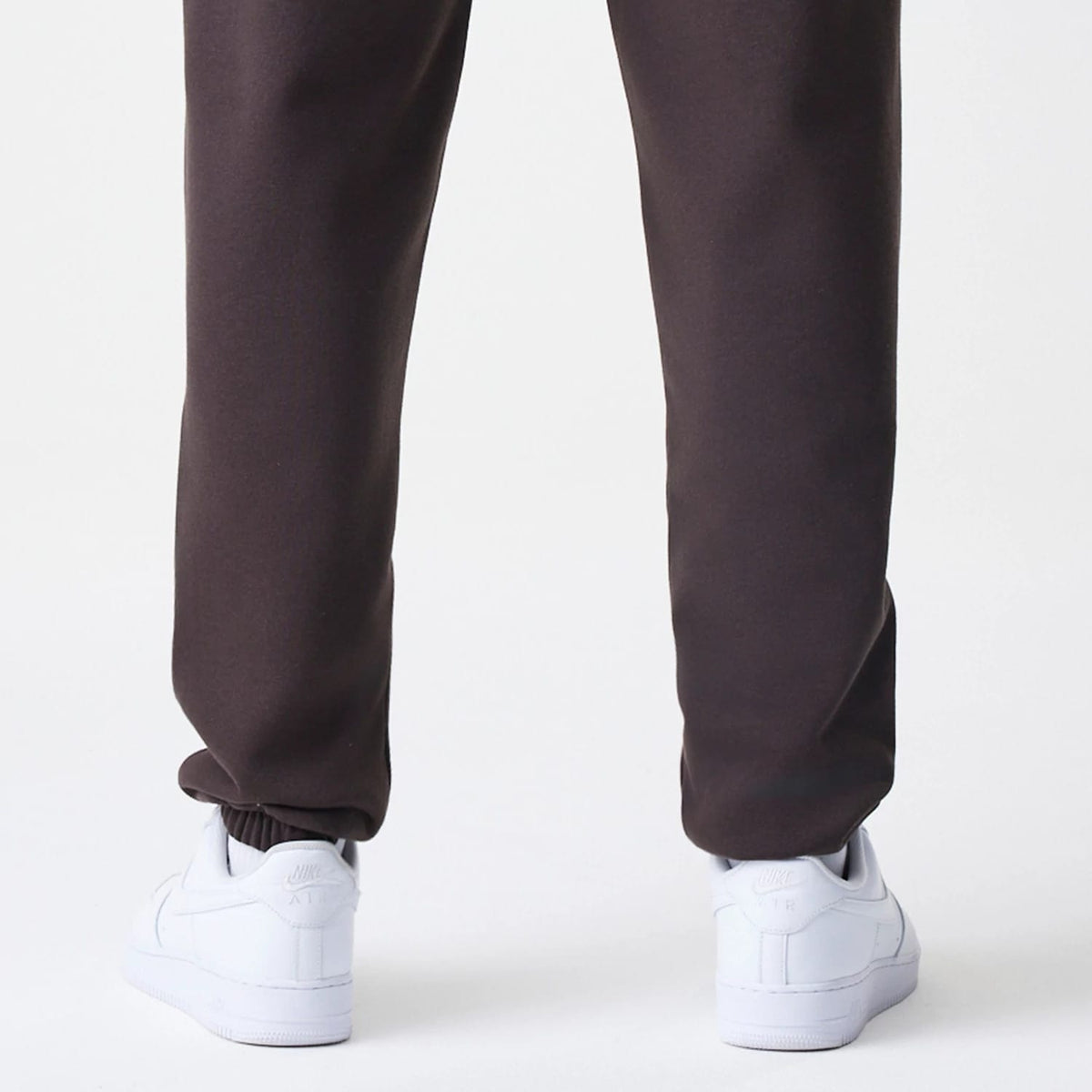 The Male model is wearing New York Yankees MLB Midi League Essential Dark Brown Joggers 4