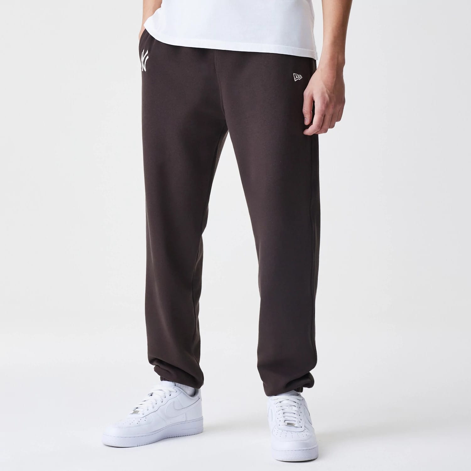 The Male model is wearing New York Yankees MLB Midi League Essential Dark Brown Joggers 1