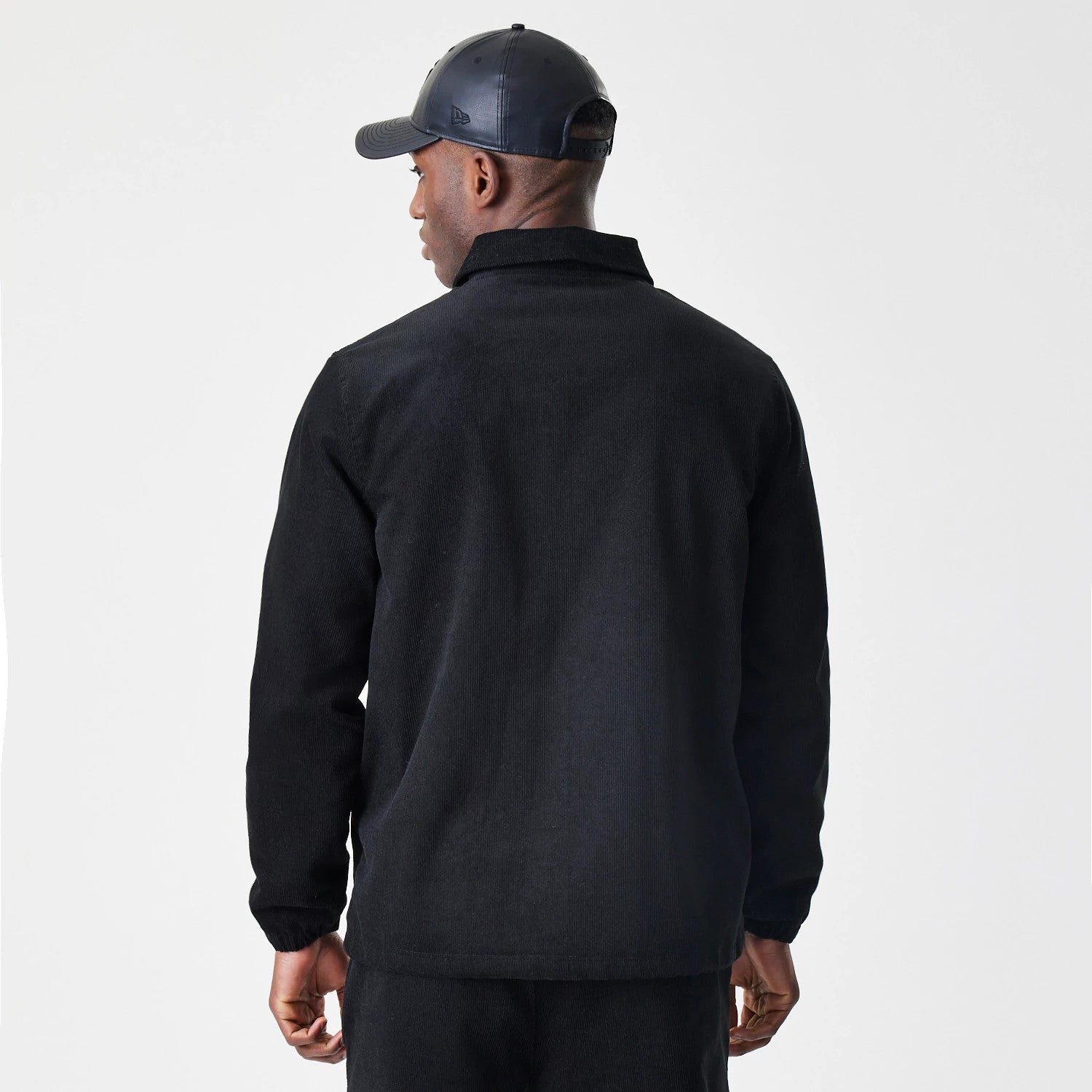 The Male model is wearing New Era Cord Black Coaches Jacket 2