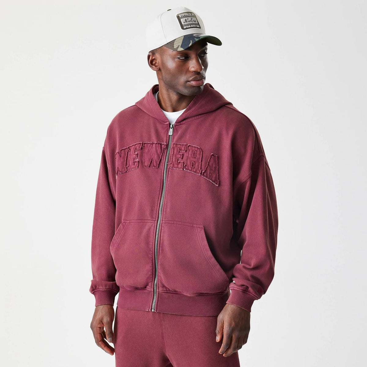 The Male model is wearing New Era Washed Dark Red Oversized Full Zip Hoodie 3