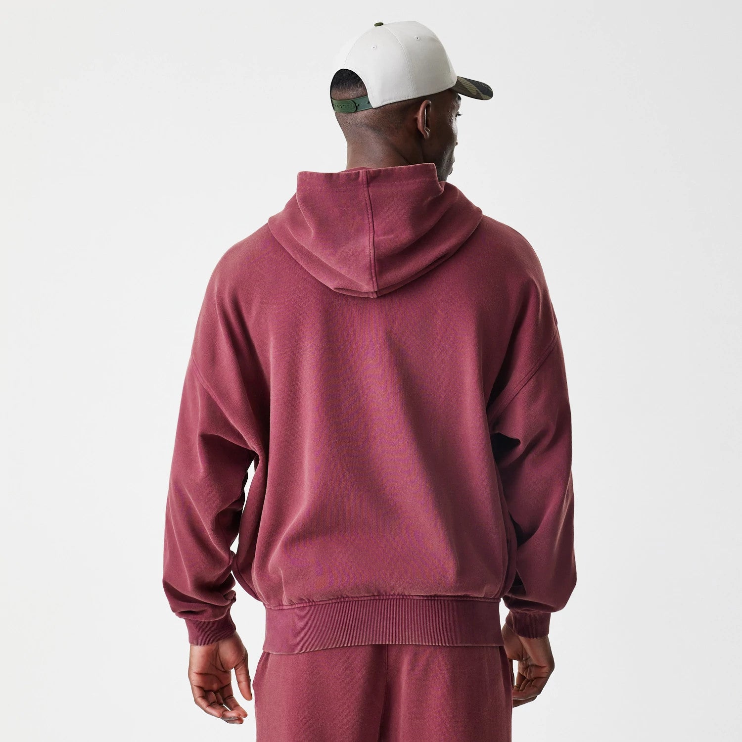 The Male model is wearing New Era Washed Dark Red Oversized Full Zip Hoodie 2
