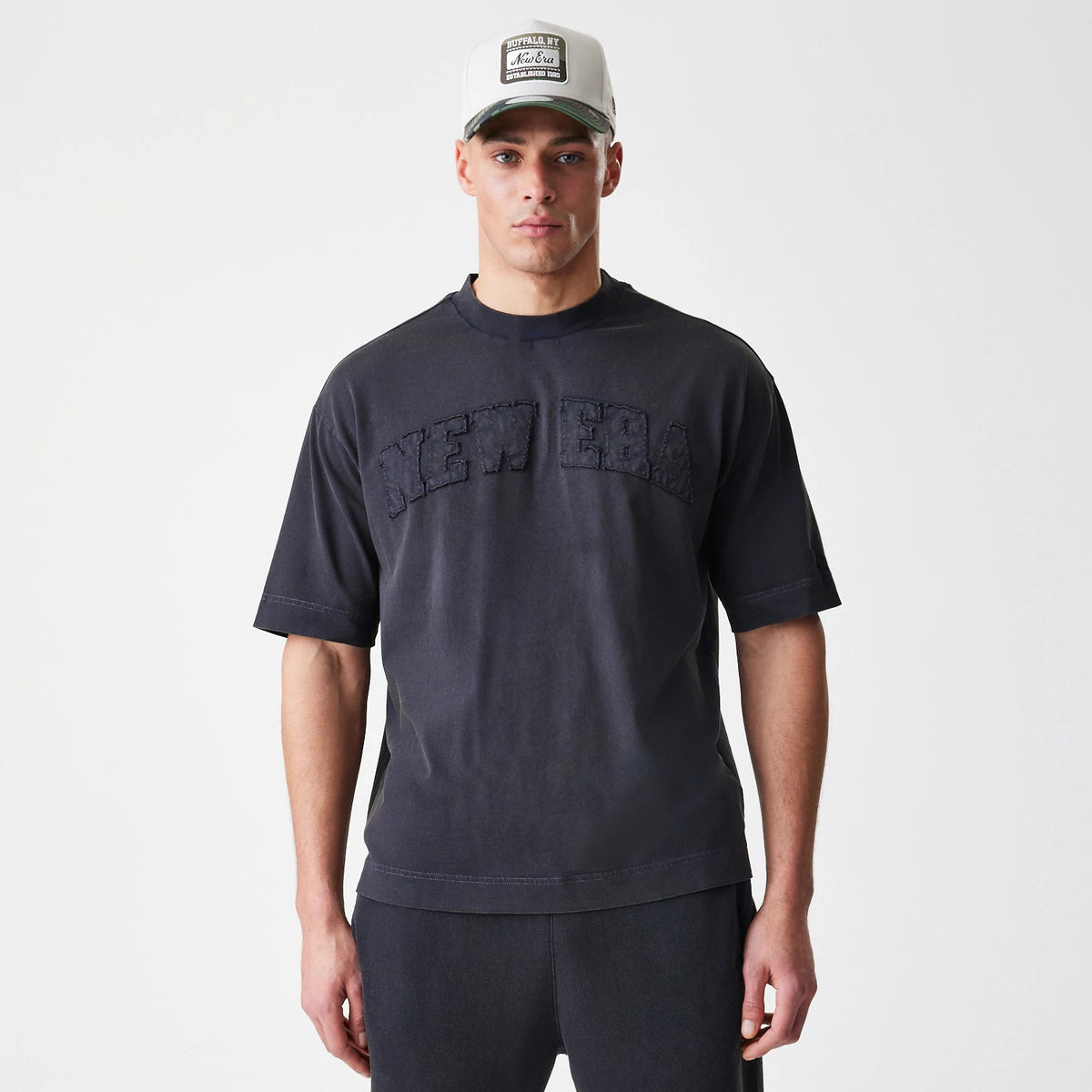 The Male model is wearing New Era Washed Black Oversized T-Shirt 3