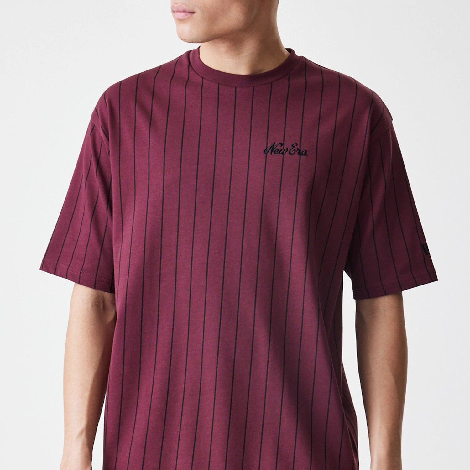 The Male model is wearing New Era Pinstripe Dark Red Oversized T-Shirt 3
