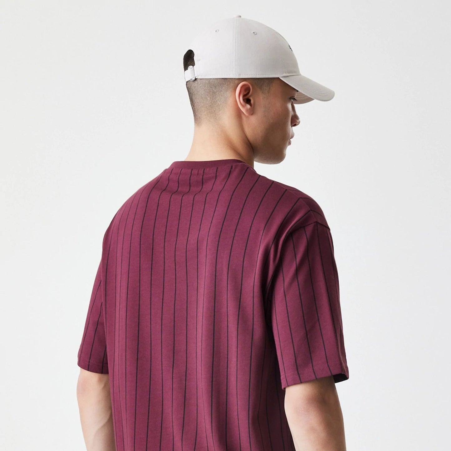 The Male model is wearing New Era Pinstripe Dark Red Oversized T-Shirt 7