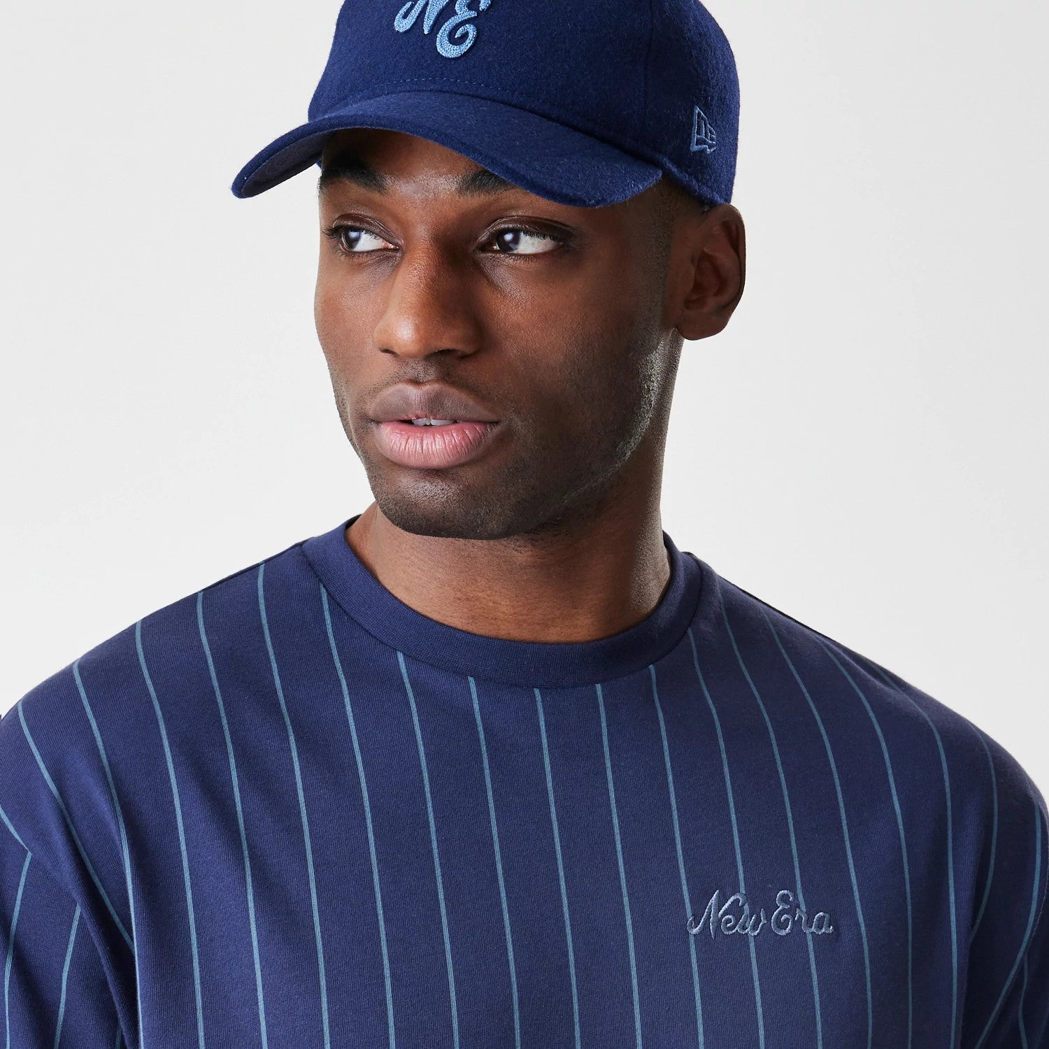 The Male model is wearing New Era Pinstripe Navy Oversized T-Shirt 4