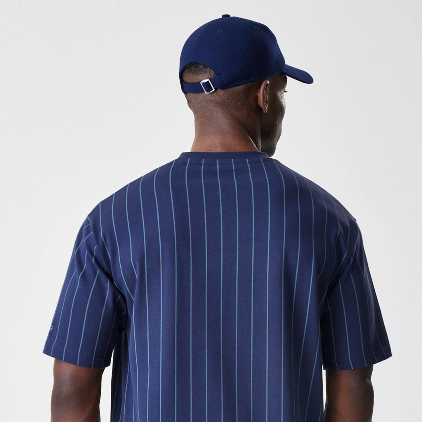 The Male model is wearing New Era Pinstripe Navy Oversized T-Shirt 7