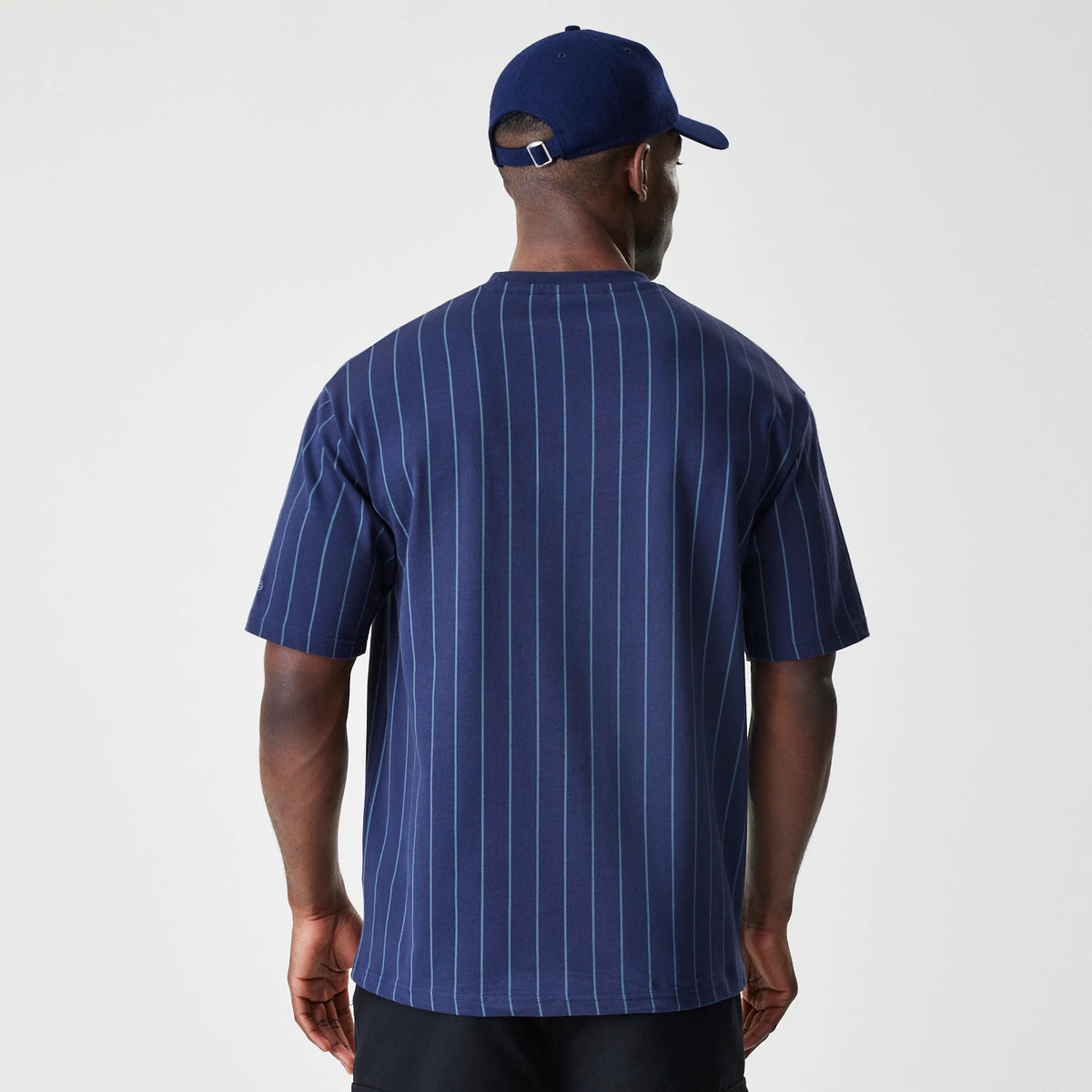 The Male model is wearing New Era Pinstripe Navy Oversized T-Shirt 2