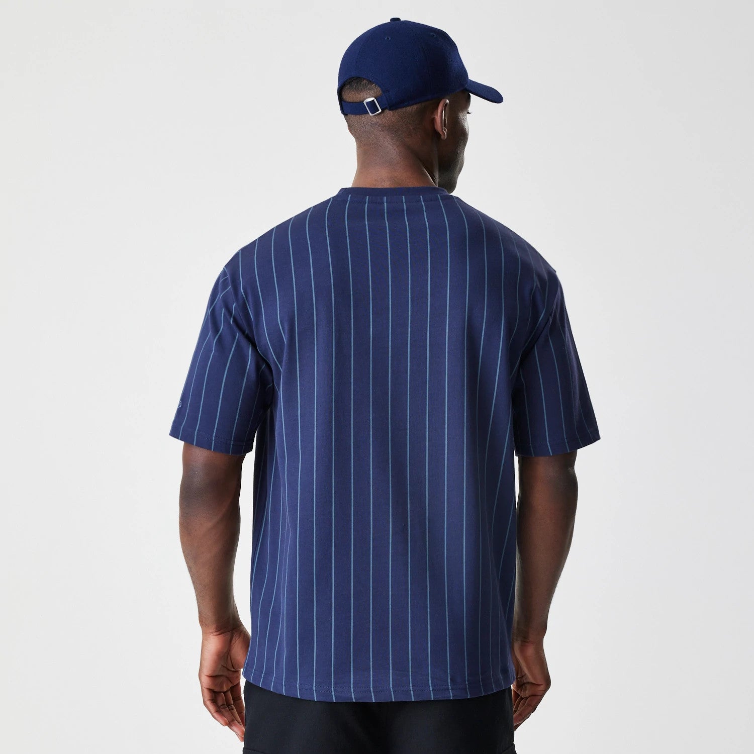 The Male model is wearing New Era Pinstripe Navy Oversized T-Shirt 2