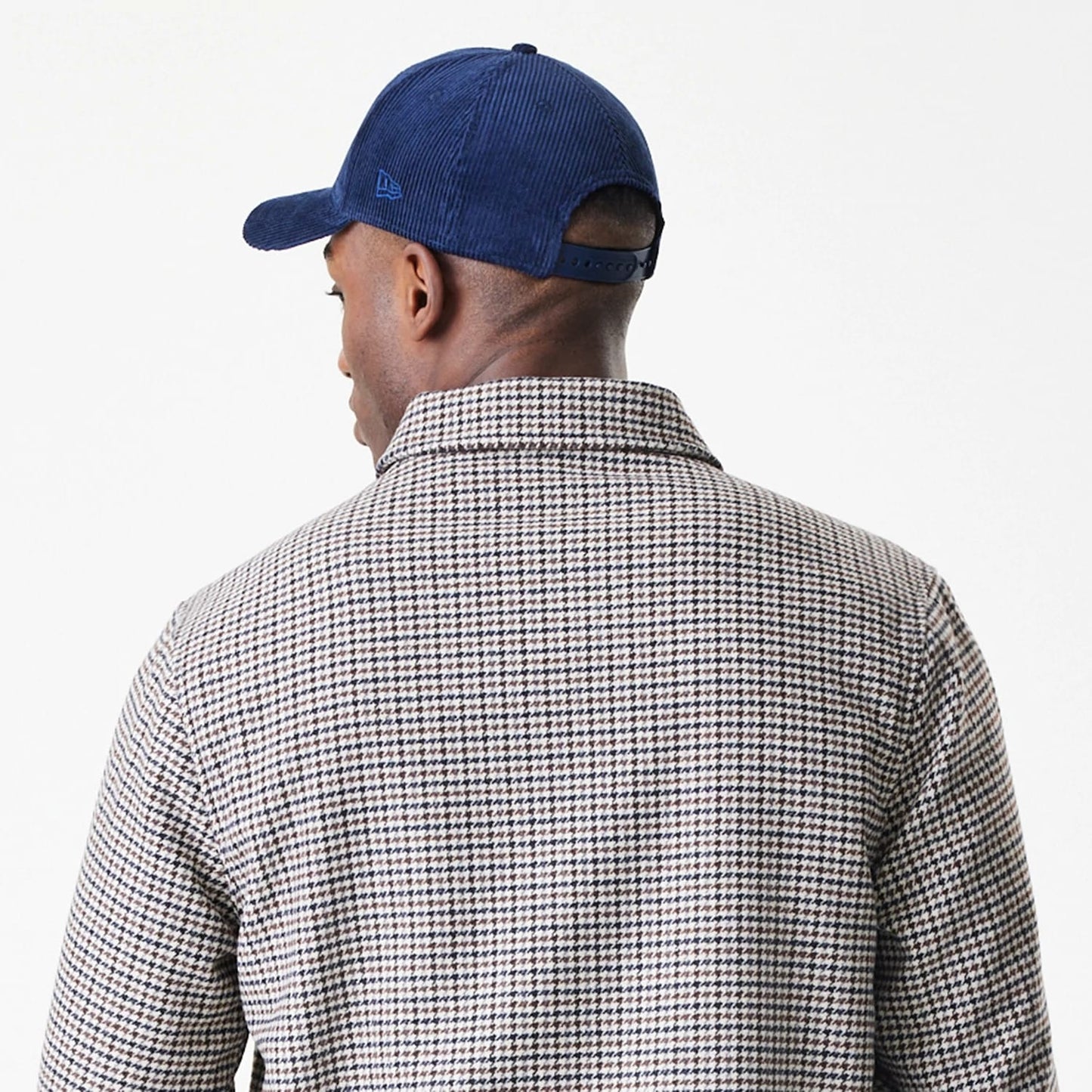 New Era New York Yankees MLB Check Brown Jacket, back view showing the classic brown check pattern on the jacket, with a collar and styled with a dark blue cap featuring an embroidered New Era logo on the side.