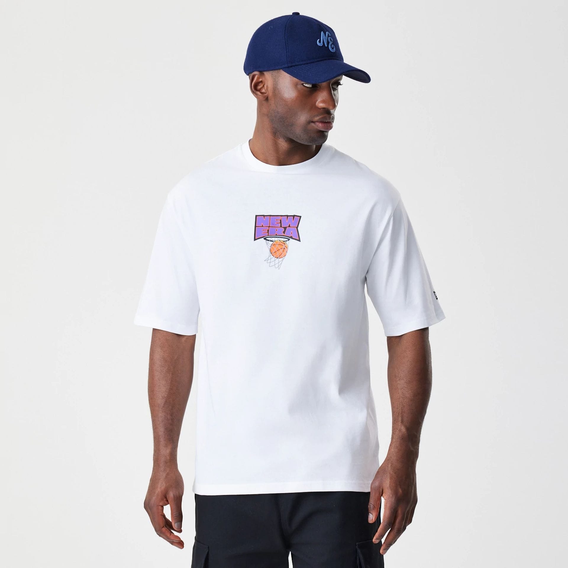The Male model is wearing New Era Location White Oversized T-Shirt 1