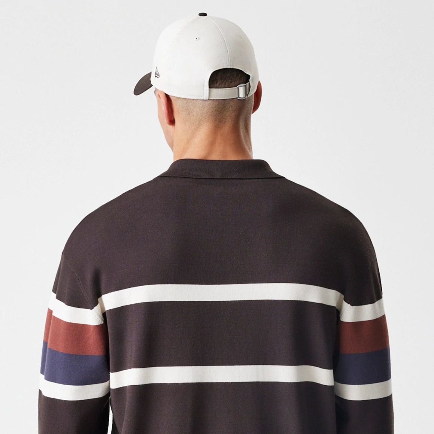 New Era LA Dodgers MLB Knit Brown Rugby Shirt, back view on a model wearing a white cap, featuring brown fabric with white horizontal stripes across the back and sleeves, with additional red and navy stripes on the sleeves.