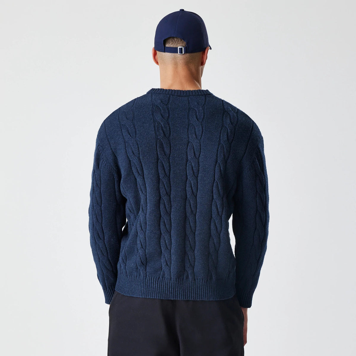 New Era New York Yankees MLB Cable Knit Navy Knitted Sweater, back view on a model showing the detailed cable knit pattern running vertically, with a ribbed hem and cuffs providing a classic textured look.