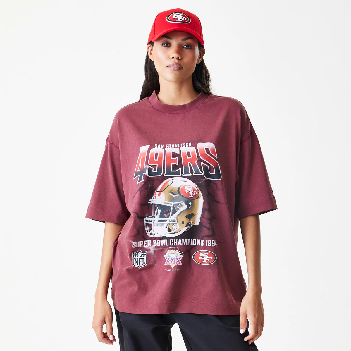 New Era San Francisco 49ers NFL Washed Boxy Dark Red Oversized T-Shirt, front view on a model showing a 49ers helmet graphic with various logos and Super Bowl Champions 1994 text printed below the team name across the chest.