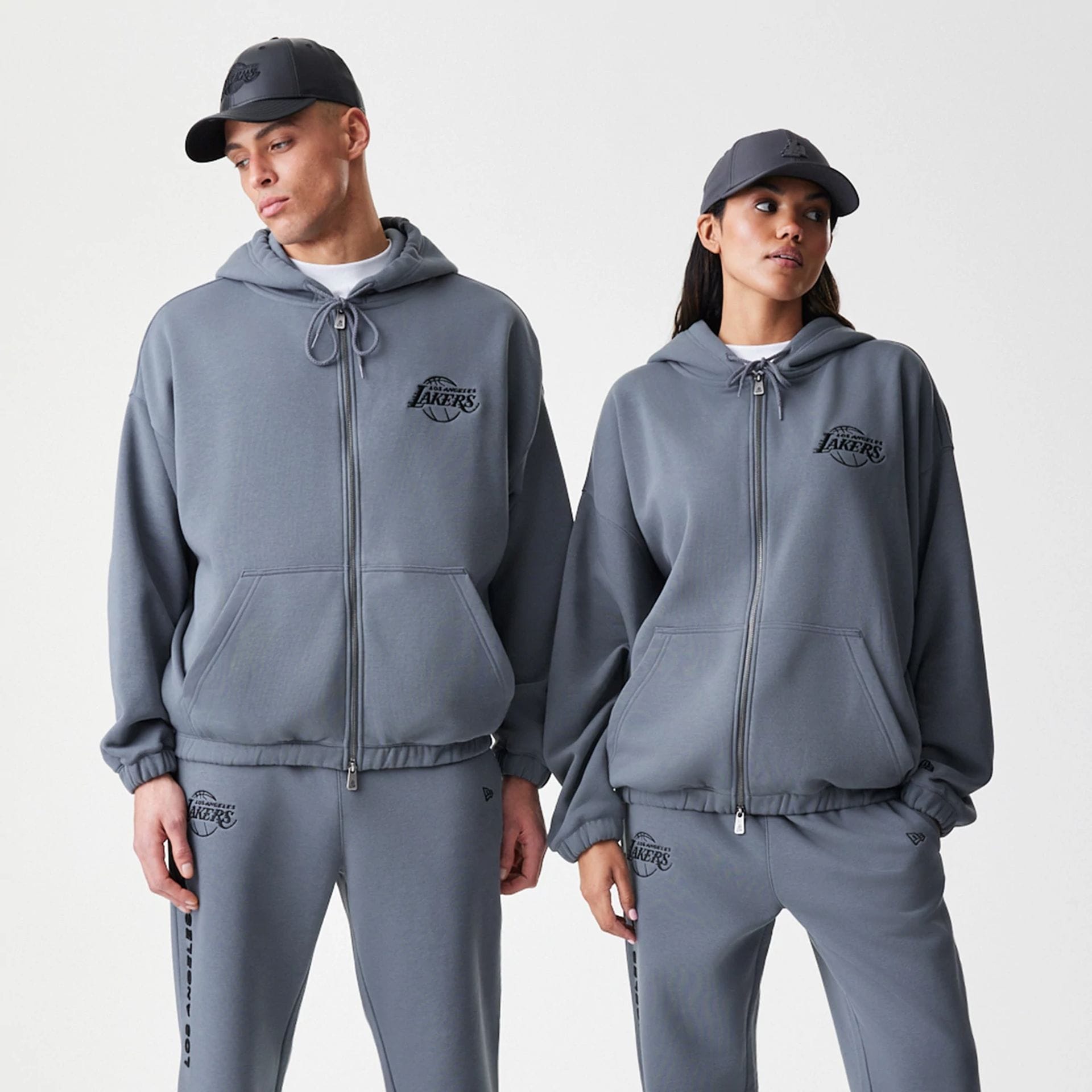 The Male model is wearing LA Lakers NBA Linear Dark Grey Oversized Full Zip Hoodie 1