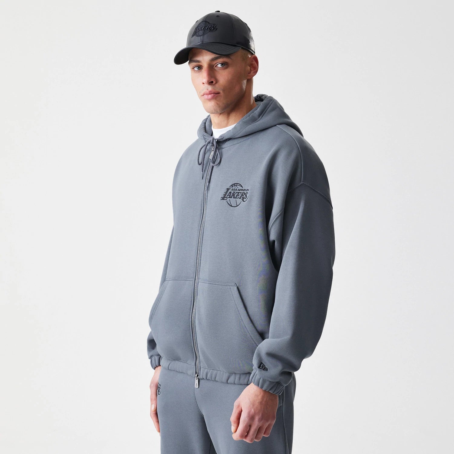 The Male model is wearing LA Lakers NBA Linear Dark Grey Oversized Full Zip Hoodie 3