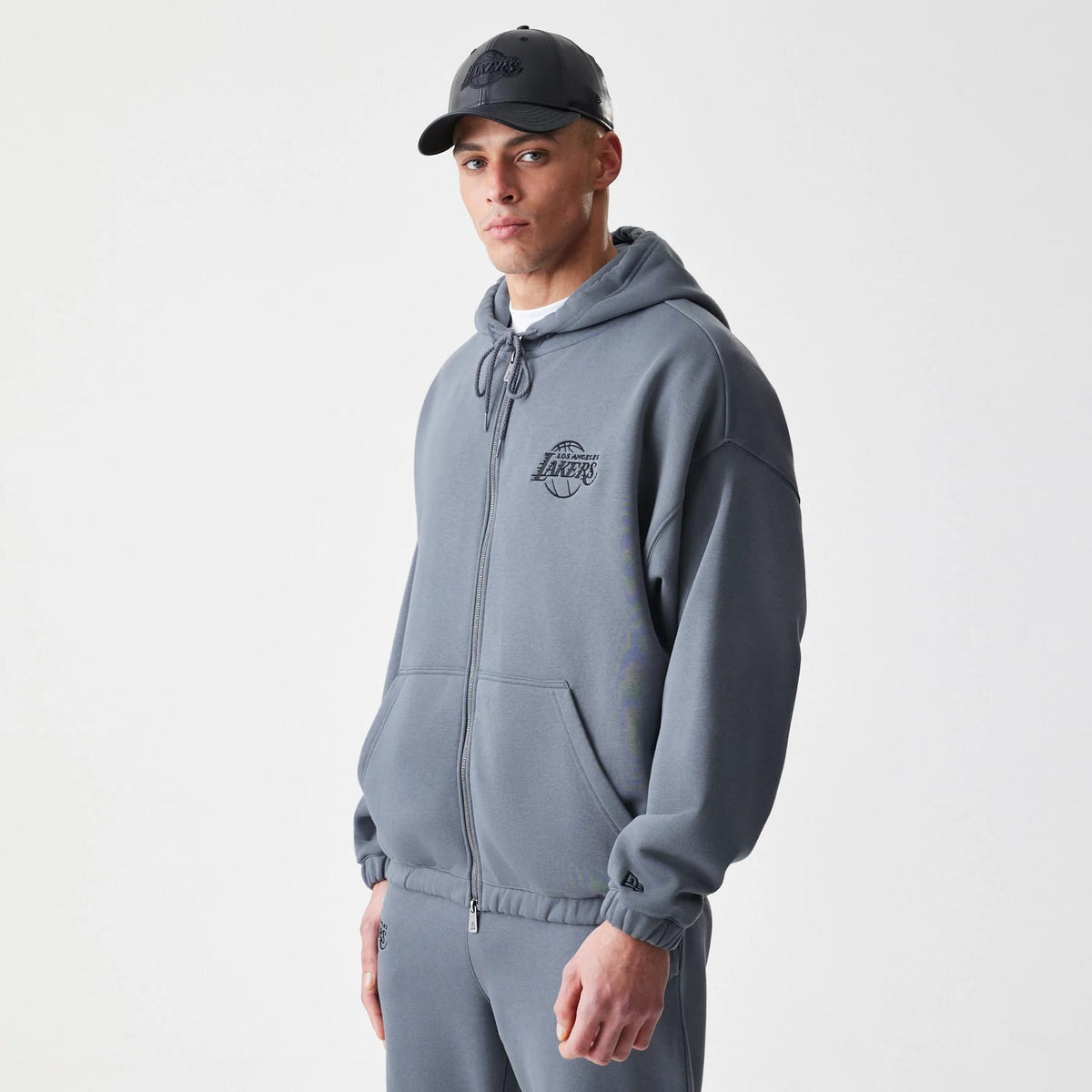 The Male model is wearing LA Lakers NBA Linear Dark Grey Oversized Full Zip Hoodie 3