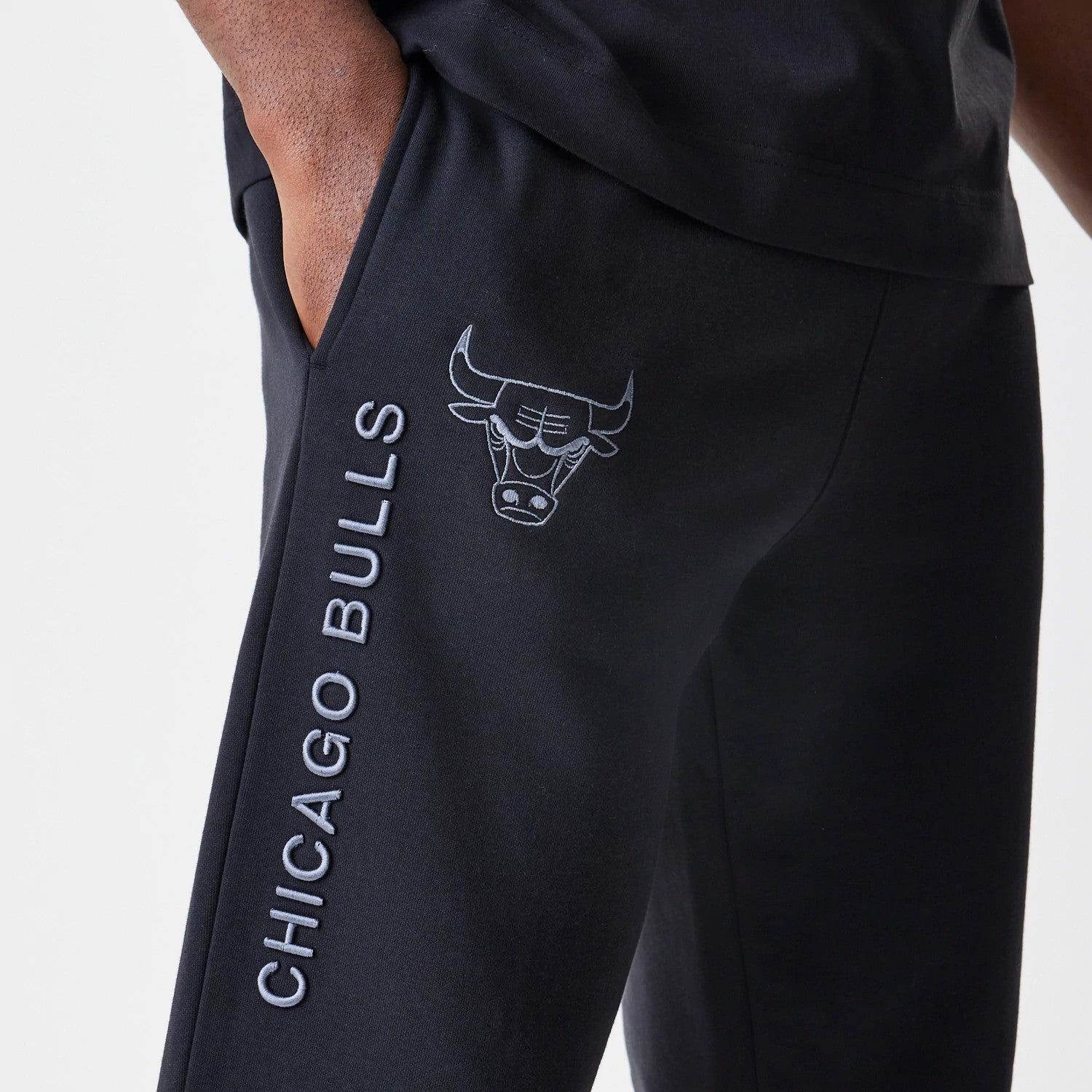 The Male model is wearing Chicago Bulls NBA Linear Black Straight Leg Joggers 4